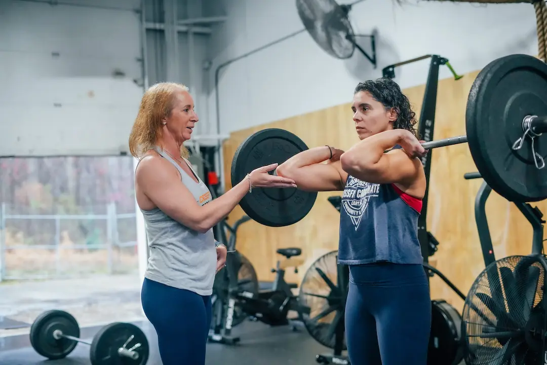 Coach guiding a member through a one-on-one personal training session at CrossFit Coordinate